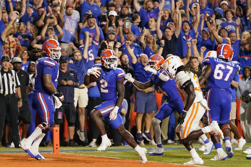 Florida running back Montrell Johnson Jr. (2) scores a touchdown past Tennessee defensive lineman Roman Harrison, front right, on an 18-yard pass play during the first half of an NCAA college football game, Saturday, Sept. 16, 2023, in Gainesville, Fla. (AP Photo/John Raoux)