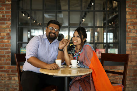 Mezbah Ul Aziz (L), 34, and Mausumi Iqbal, 33, pose for a photo in a coffee shop where they hang out on a regular basis in Dhaka, Bangladesh, February 7, 2018. "Our story was not love-at-first-sight type. In fact, we used to remain at opposite ends of the class mostly when we met first, but you know about magic, it always happens with surprises. Both of us are dentists and married for eight years now. Before that, we met at our dental school on June 1, 2004, on the first day of the class. We both were invited to give a short speech before our classmates and teachers. I went first, and later him. We never admitted, but maybe we felt some spark on the first day, but it was definitely not love. Later, we chose different paths, chose different reading partners for daily life. But fate brought us together after a year and a half. I was being bullied by some of my friends and my reading partners, then he came out of nowhere. He did not need to help me, but he did. From that day, we started our journey together. Our story was being written as one by fate and now, we have a treasure too, our five-year-old daughter, the centre of our attraction, the sign of our love," said Mausumi. REUTERS/Mohammad Ponir Hossain