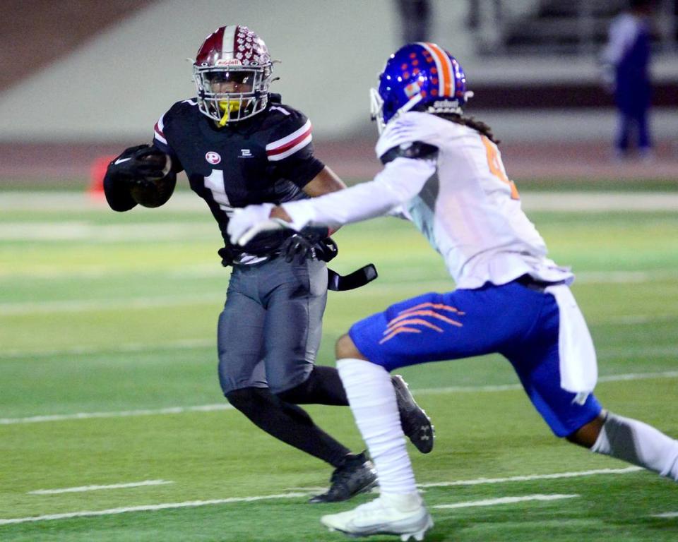 Patterson running back Jeremiah Lugo (1) tries to evade a Kimball defender during a Division IV Sac Joaquin Section Football Playoff game between Patterson and Kimball at Patterson High School in Patterson CA on November 10, 2023.
