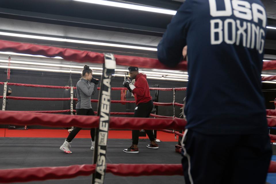 Nov 25, 2023; East Hanover, NJ, USA; Elise Soto, 18, and her trainer Shaun George at the Fitness Superstore LLC basement gym. Elise Soto is preparing to compete in boxing at the Olympic Trials..