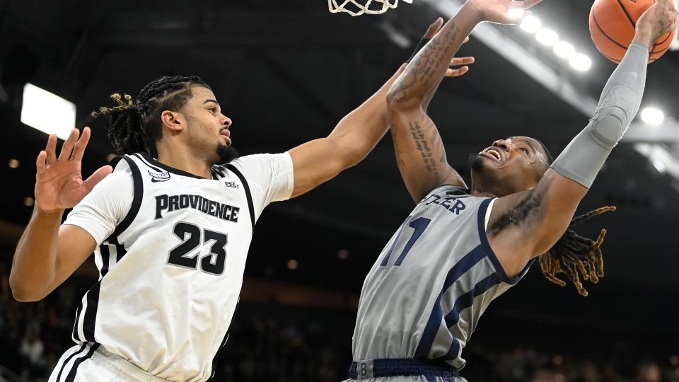 Dec 23, 2023; Providence, Rhode Island, USA; Providence Friars forward Bryce Hopkins (23) defends against a shot by Butler Bulldogs guard Jahmyl Telfort (11) during overtime at Amica Mutual Pavilion. Mandatory Credit: Eric Canha-USA TODAY Sports