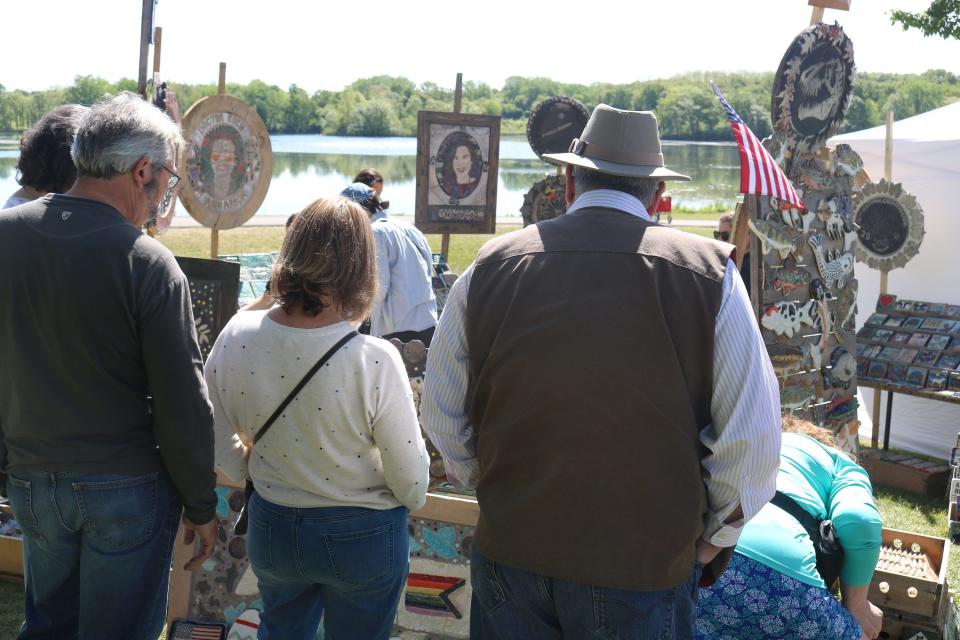 Guests at the water admiring at near the lake at Stony Creek Art Fair.