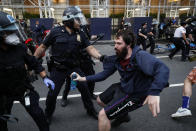 A protester is arrested for violating curfew near the Plaza Hotel on Wednesday, June 3, 2020, in the Manhattan borough of New York. Protests continued following the death of George Floyd, who died after being restrained by Minneapolis police officers on May 25. (AP Photo/John Minchillo)