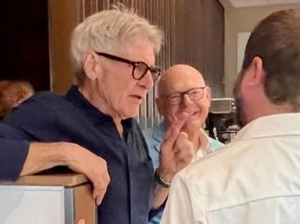 Actor Harrison Ford, left, with chef Blaine Staniford, right, and owner Adam Jones at 61 Osteria in downtown Fort Worth.