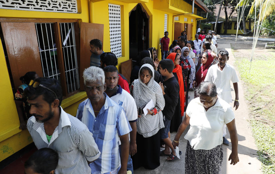 Sri Lankans queue to cast their votes at a polling station during the presidential election in Colombo, Sri Lanka, Saturday, Nov. 16, 2019. Polls opened in Sri Lanka’s presidential election Saturday after weeks of campaigning that largely focused on national security and religious extremism in the backdrop of the deadly Islamic State-inspired suicide bomb attacks on Easter Sunday. (AP Photo/Eranga Jayawardena)