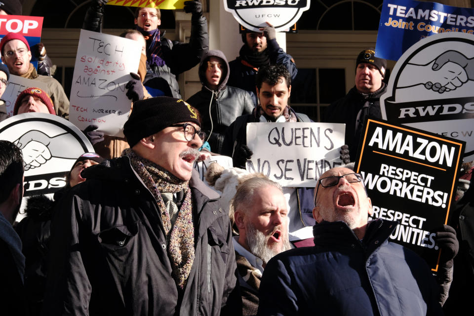 George Miranda, vice president of the International Brotherhood of Teamsters, left, and Stuart Appelbaum, president of the Retail Wholesale Department Store Union (RWDU), speak during a protest against Amazon outside of City Hall in New York, U.S., on Wednesday, Jan. 30, 2019. New York's city council held a hearing today to discuss the tax incentives behind Amazon's HQ2 deal and the potential impact it could have on the city. Photographer: Sangsuk Sylvia Kang/Bloomberg via Getty Images