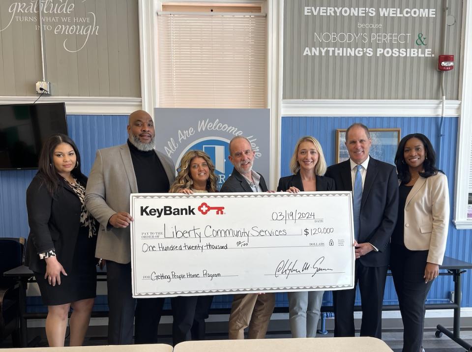 Liberty Community Services Executive Director Jim Pettinelli (center) receives a grant in the amount of $120,000 from KeyBank Foundation, presented by KeyBank leaders (from left) Vanity Bryant, Consumer Consultant; Dwayne Hicks, Branch Manager; Tracy Menges, Regional Community Sales Manager; Elona Shape, Market Retail Leader; Matthew Hummel, Market President; and Rachael Sampson, Director of Community Banking.