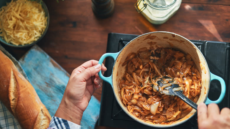 Person stirring caramelized onions for French onion soup