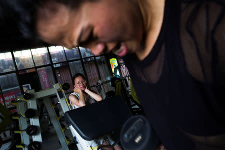 Huang Wensi's sister watches her training at a local gym in Lianjiang, Guangdong province, China, June 30, 2018. REUTERS/Yue Wu