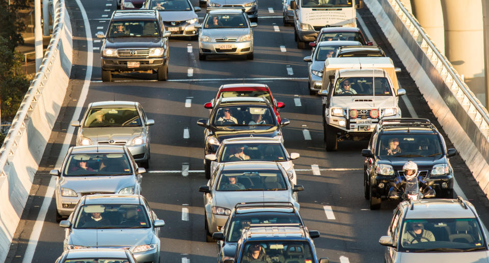 Cars in traffic on busy road. 