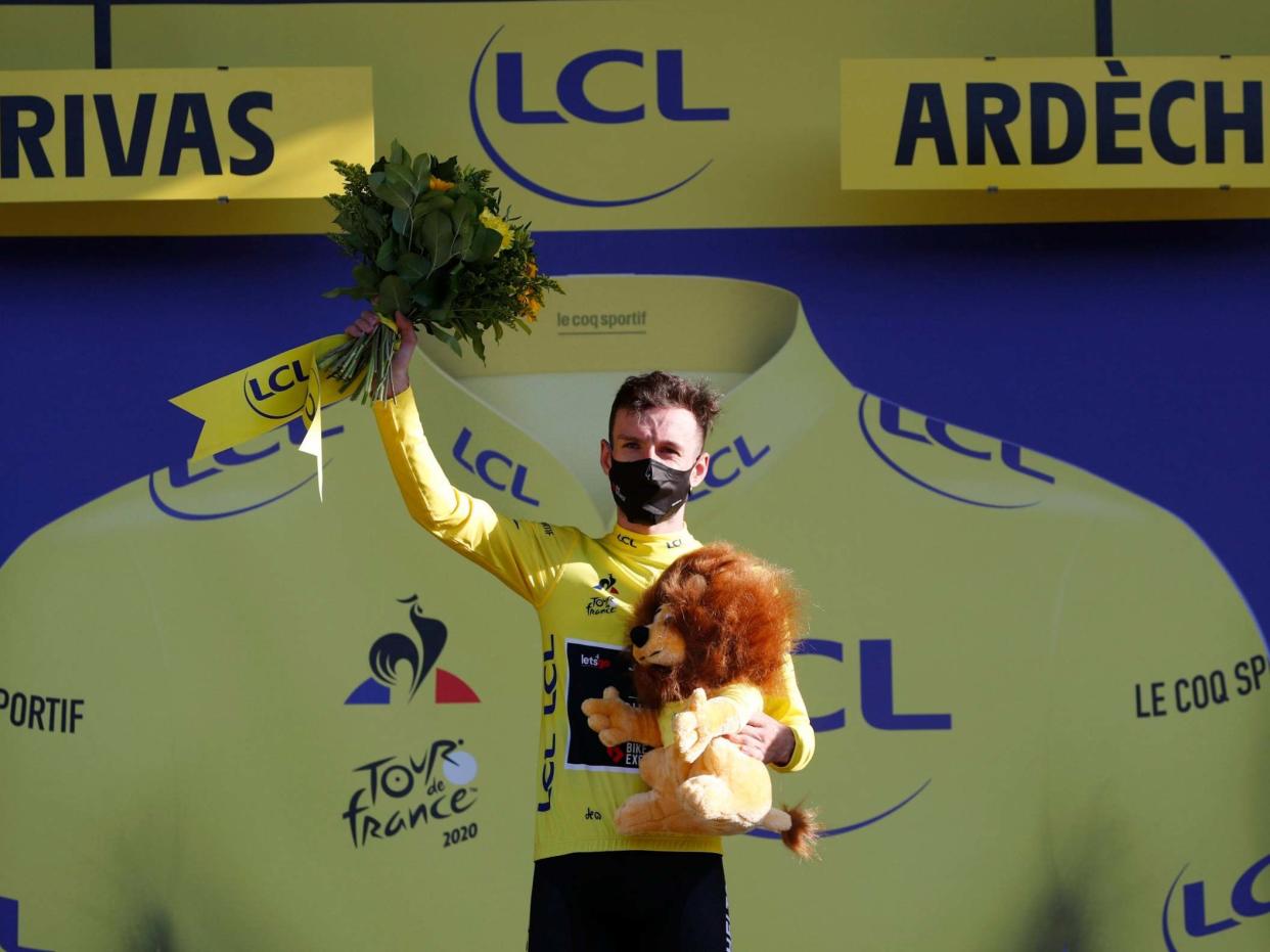 Adam Yates celebrates after earning the yellow jersey: Reuters