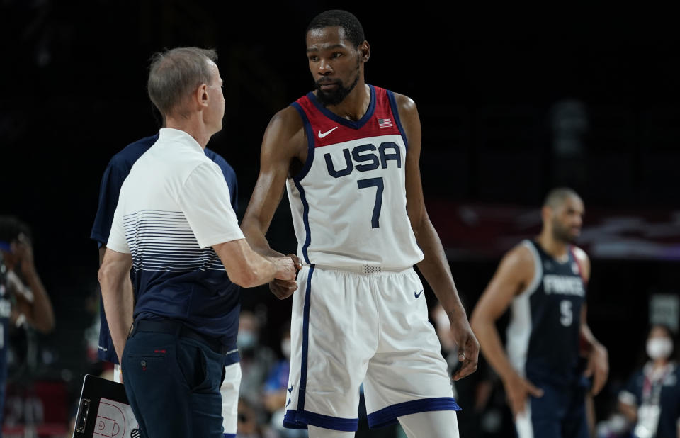 United States' Kevin Durant (7) shakes hands with France head coach Vincent Collet, left, after United States won the men's basketball gold medal game at the 2020 Summer Olympics, Saturday, Aug. 7, 2021, in Saitama, Japan. (AP Photo/Charlie Neibergall)