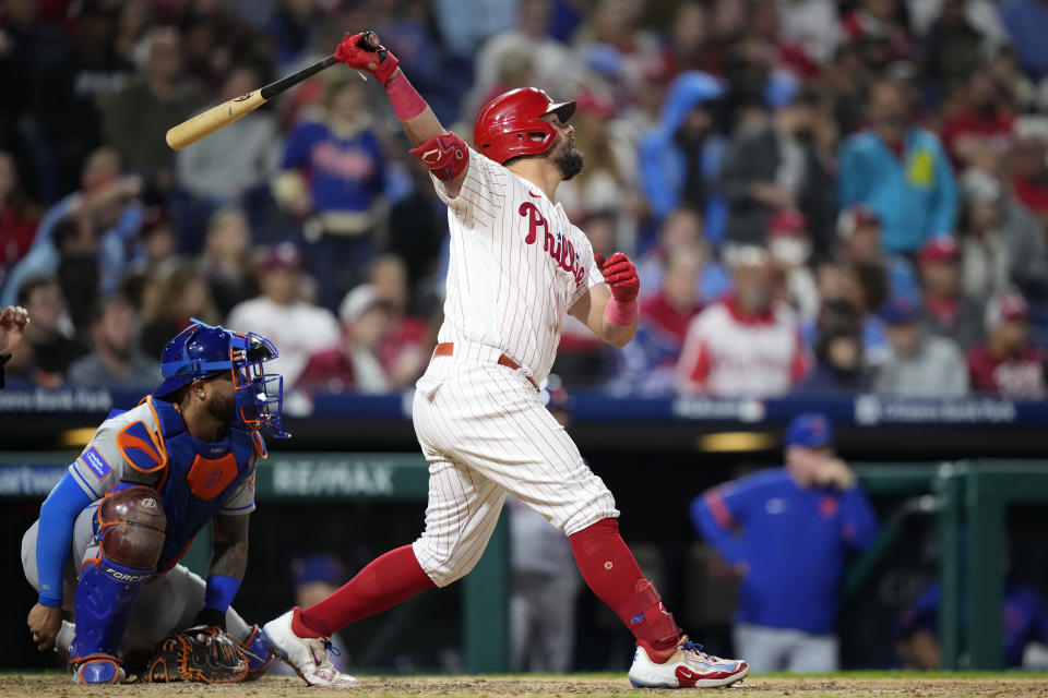 Philadelphia Phillies' Kyle Schwarber follows through after hitting a run-scoring single against New York Mets pitcher Phil Bickford during the seventh inning of a baseball game, Friday, Sept. 22, 2023, in Philadelphia. (AP Photo/Matt Slocum)