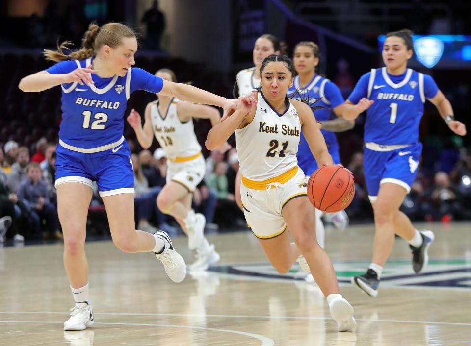 Kent State's Dionna Gray (21) drives against Buffalo's Paula Lopez (12) during the first half of the Mid-American Conference Tournament women's championship game Saturday in Cleveland.