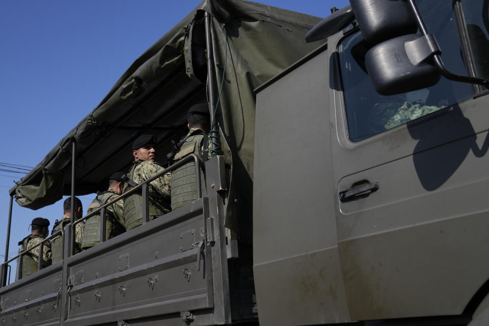 Security forces arrive to Litoral Penitentiary after deadly fights inside the jail in Guayaquil, Ecuador, Thursday, July 22, 2021. Rival gangs of inmates fought in two prisons in Ecuador, killing at least 18 people and injuring dozens, authorities said Thursday. (AP Photo/Dolores Ochoa)