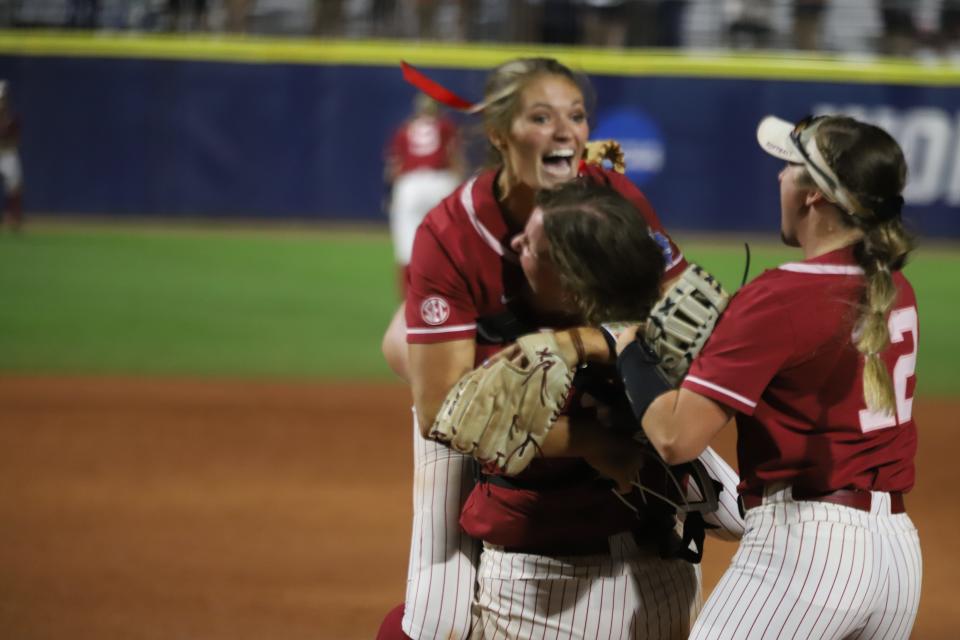 Alabama catcher Bailey Hemphill hugs Montana Fouts. Alabama softball defeated the UCLA Bruins 6-0 during the Women's College World Series in Oklahoma City on Friday, June 4, 2021.