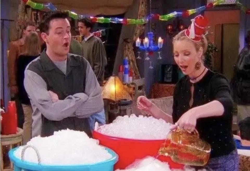 Chandler watching Phoebe pour a beverage over the ice