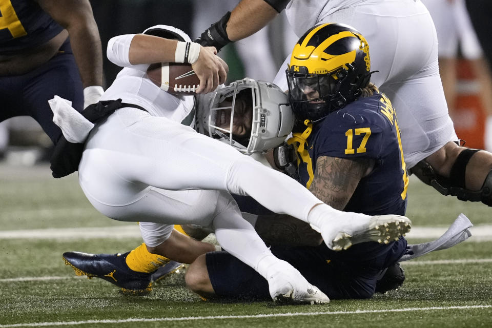 Michigan linebacker Braiden McGregor (17) sacks Michigan State quarterback Payton Thorne (10) in the second half of an NCAA college football game in Ann Arbor, Mich., Saturday, Oct. 29, 2022. (AP Photo/Paul Sancya)