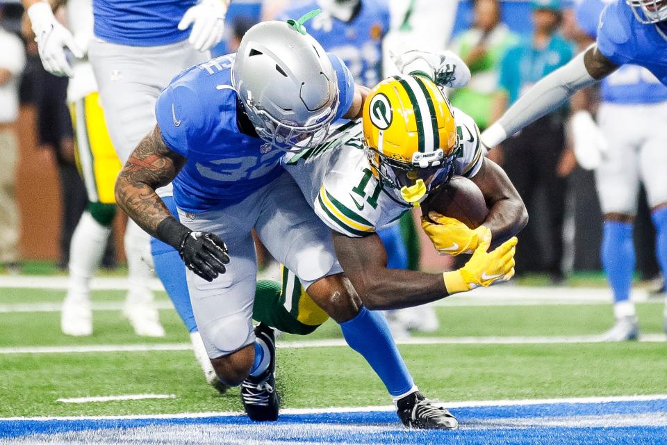 Green Bay Packers receiver Jayden Reed catches a touchdown against Detroit Lions safety Brian Branch during the first quarter at Ford Field.