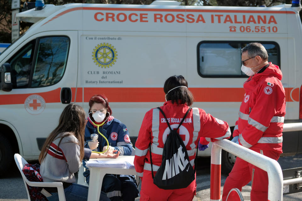 A woman donates blood at a Red Cross mobile unit in Rome, Saturday April 4, 2020. The government is demanding Italians stay home and not take the leveling off of new coronavirus infections as a sign the emergency is over, following evidence that more and more Italians are relaxing restrictions the west’s first and most extreme nationwide lockdown and production shutdown. (Mauro Scrobogna/LaPresse via AP)