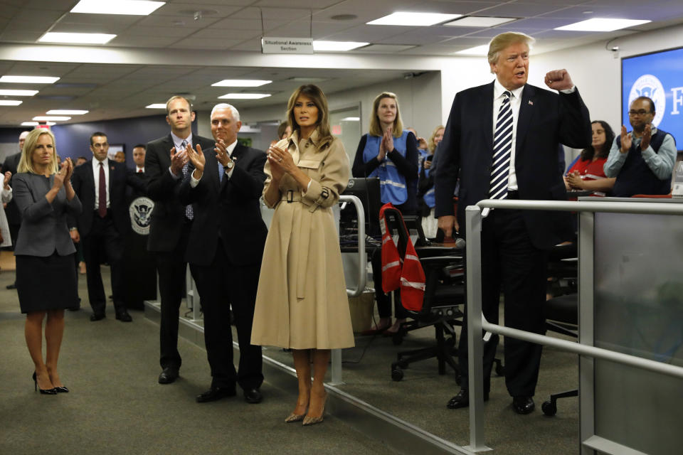 U.S. President Donald Trump, along with first lady Melania Trump and U.S. Vice President Mike Pence, greets employees at the National Response Coordination Center at the Federal Emergency Management Agency Headquarters.