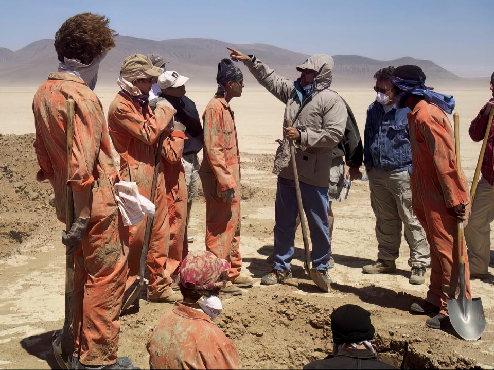 andy directing the kids in holes in the desert