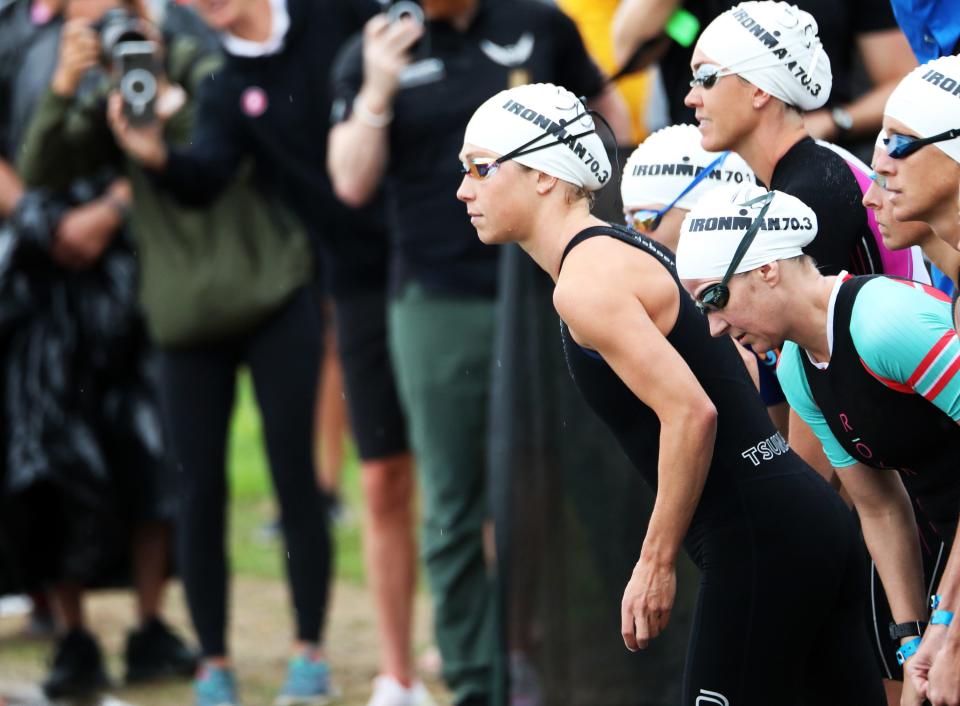 Womens Pro get ready to start swimming during the inaugural edition of the Ironman 70.3 mile Des Moines Triathlon as athletes compete in a 1.2-mile swim at Gray’s Lake, 56.0 mile bike race (shortened due to 3-hour rain delay), and a 13.1 mile run in Des Moines.