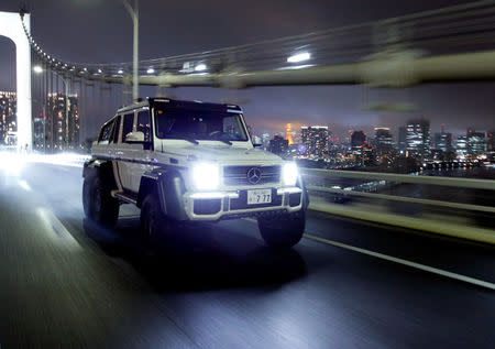 Supercar collector Takeshi Kimura drives Mercedes-Benz AMG G63 6x6 on the Rainbow Bridge in Tokyo, Japan October 20, 2017. Picture taken October 20, 2017. REUTERS/Toru Hanai