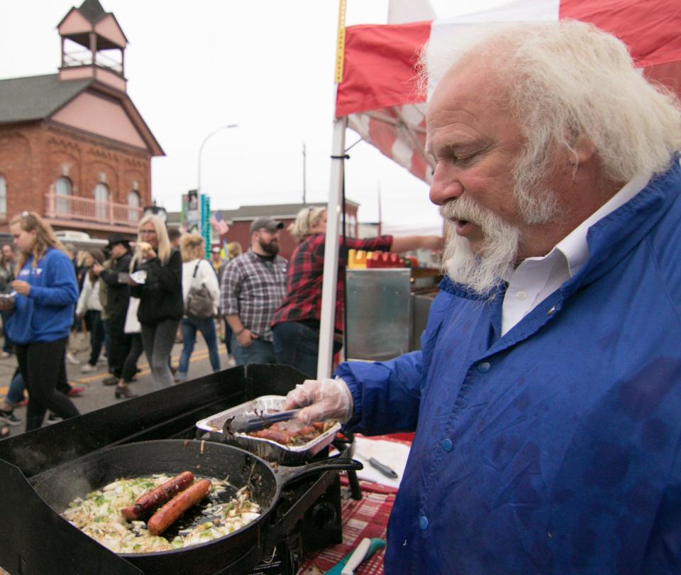 Tony Poma of Tony's Dogs prepares Polish kielbasa with sautéed onions and peppers at Brighton's Smokin' Jazz and Barbecue Blues Fest Saturday, Sept. 8, 2018.