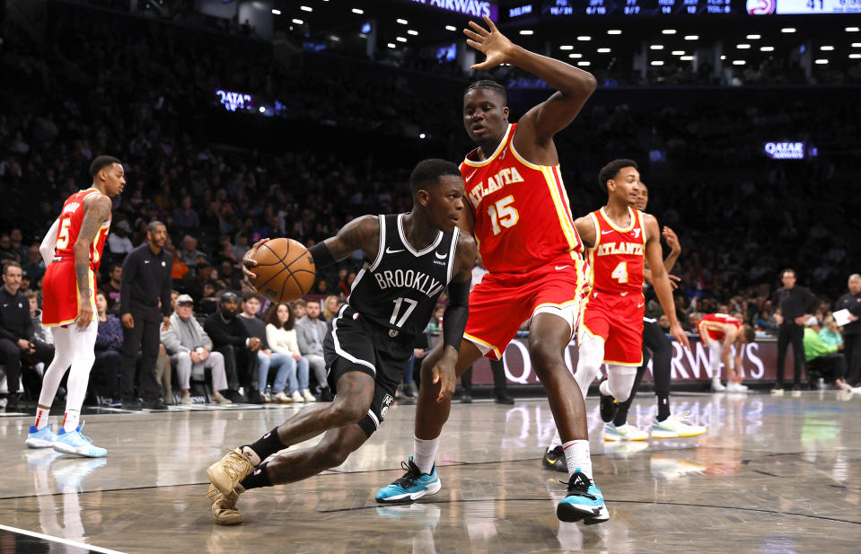 Brooklyn Nets guard Dennis Schroder (17) drives the baseline against Atlanta Hawks center Clint Capela (15) during the first half of an NBA basketball game, Saturday, March 2, 2024, in New York. (AP Photo/Noah K. Murray)