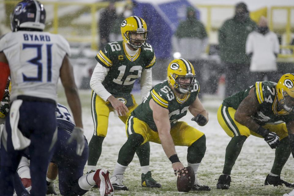 Green Bay Packers' Corey Linsley snaps the ball to Aaron Rodgers during the first half of an NFL football game against the Tennessee Titans Sunday, Dec. 27, 2020, in Green Bay, Wis. (AP Photo/Mike Roemer)