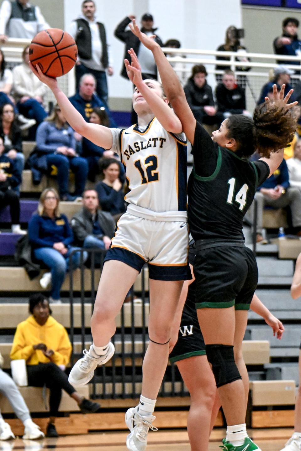 Haslett's Avery Hannah, left, shoots as Williamston's Jaiden Griffith defends during the third quarter on Friday, March 8, 2024, at Fowlerville High School.