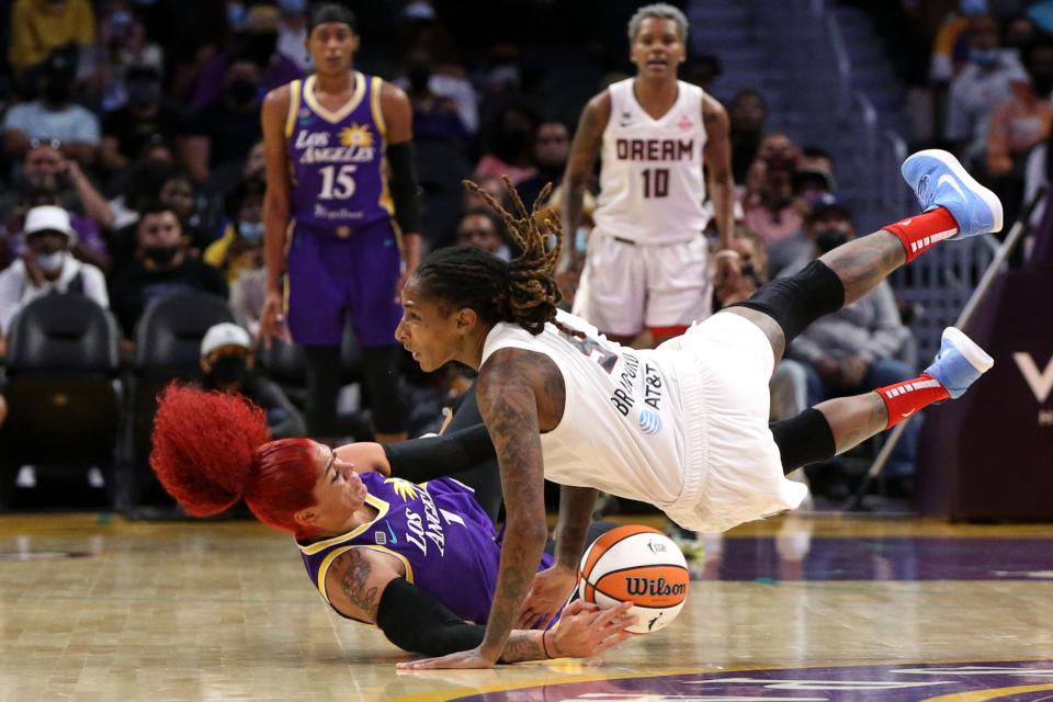 Amanda Zahui B (left) and Crystal Bradford battle for a loose ball during the first half of a WNBA game between the Los Angeles Sparks and Atlanta Dream.