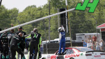 A.J. Allmendinger celebrates on the track after winning the B&L Transport 170 NASCAR Xfinity Series auto race at Mid-Ohio Sports Car Course on Saturday, June 5, 2021, in Lexington, Ohio. (AP Photo/Tom E. Puskar)