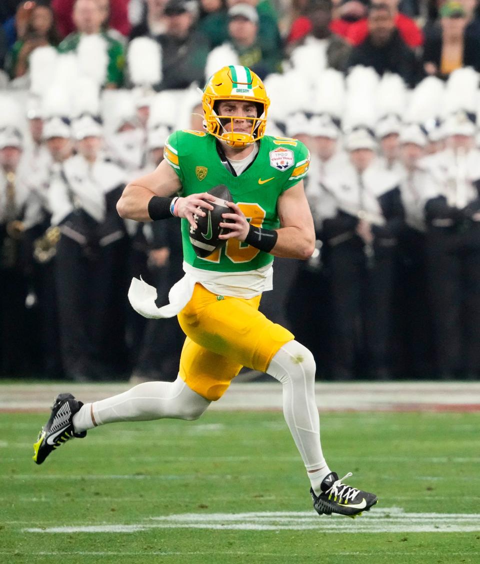 Oregon Ducks quarterback Bo Nix (10) carries the ball against the Liberty Flames in the first half during the Fiesta Bowl at State Farm Stadium in Glendale on Jan 1, 2024.