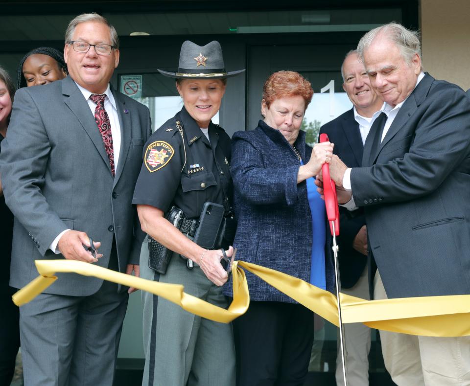 Tallmadge Mayor Dave Kline, Summit County Sheriff Kandy Fatheree, Summit County Executive Ilene Shapiro, Akron Mayor Dan Horrigan, and contractor Paul Thomarios cut the ceremonial ribbon at the Summit Emergency Communications Center on Friday in Tallmadge.