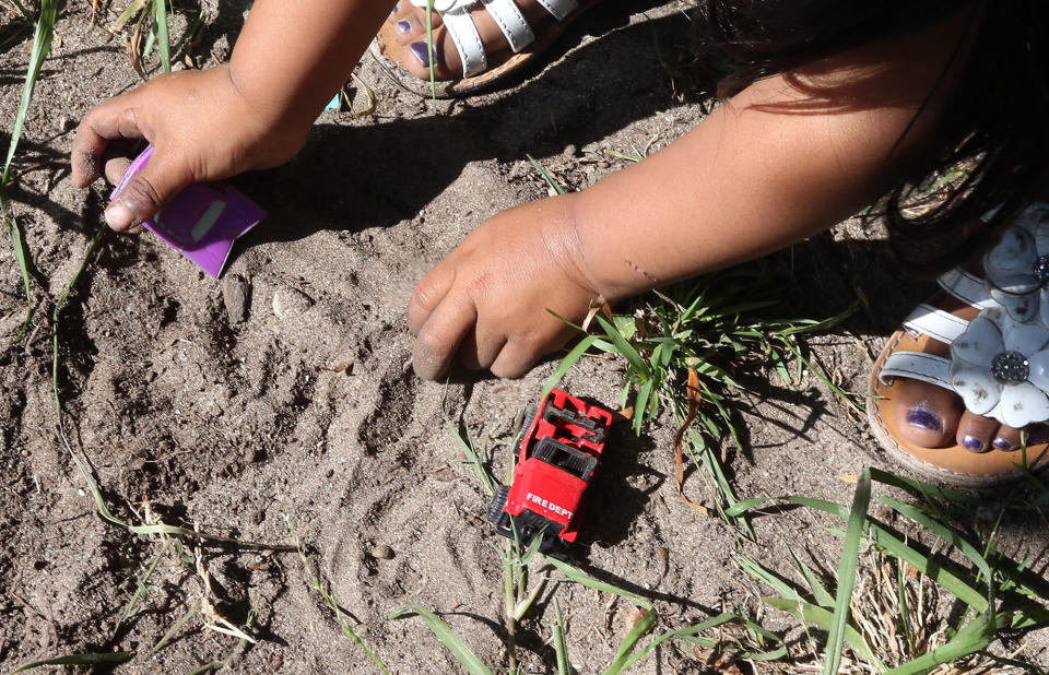 A 2-year-old California girl plays in soil that tested positive for hazardous levels of lead. In a new Illinois pilot study, advocates hope to make environmental factors a stronger determinant for early intervention support. (Photo: DANIEL A. ANDERSON FOR HUFFPOST)