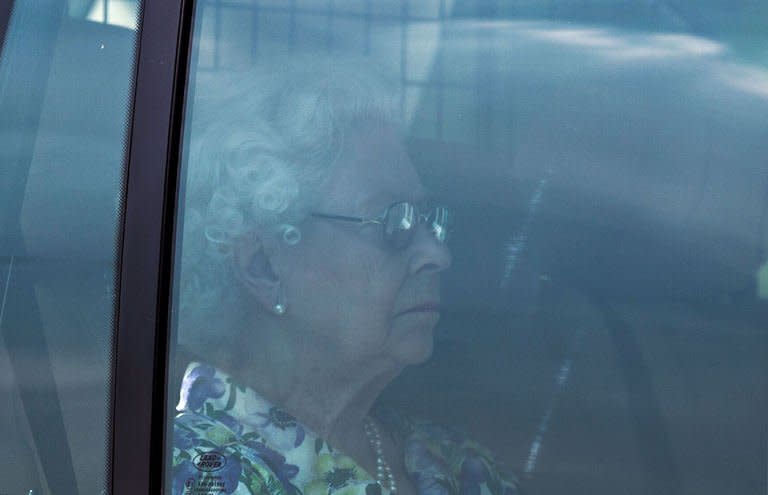 Britain's Queen Elizabeth II returns in a car to Buckingham Palace in London on July 22, 2013