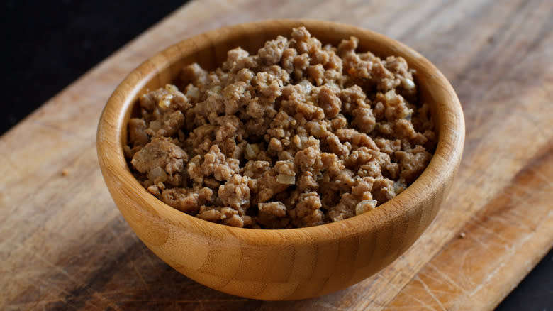 Ground meat in wooden bowl