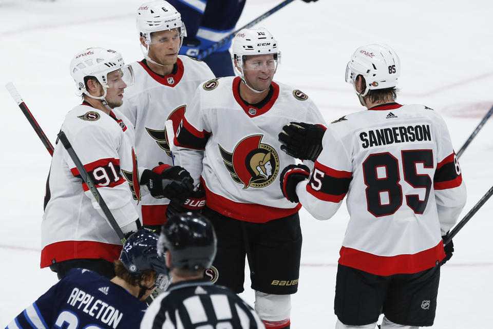 Ottawa Senators' Vladimir Tarasenko (91), Jakob Chychrun (6), Josh Bailey (16) and Jake Sanderson (85) celebrate Bailey's goal against the Winnipeg Jets during the second period of an NHL hockey preseason game Thursday, Oct. 5, 2023, in Winnipeg, Manitoba. (John Woods/The Canadian Press via AP)