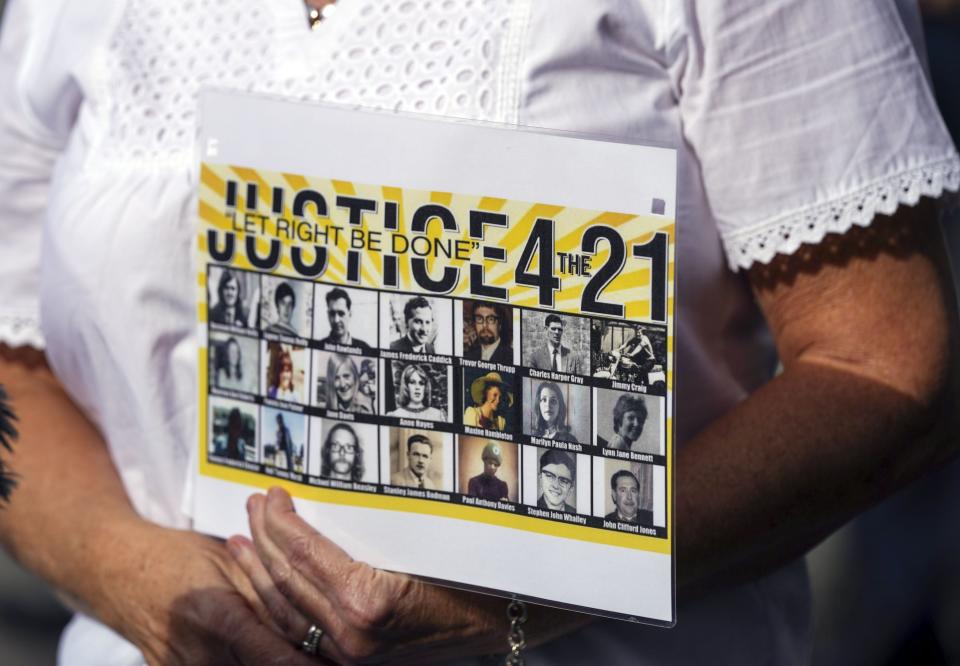 Julie Hambleton holds up a sign while speaking to media (Steve Parsons/PA) (PA Wire)