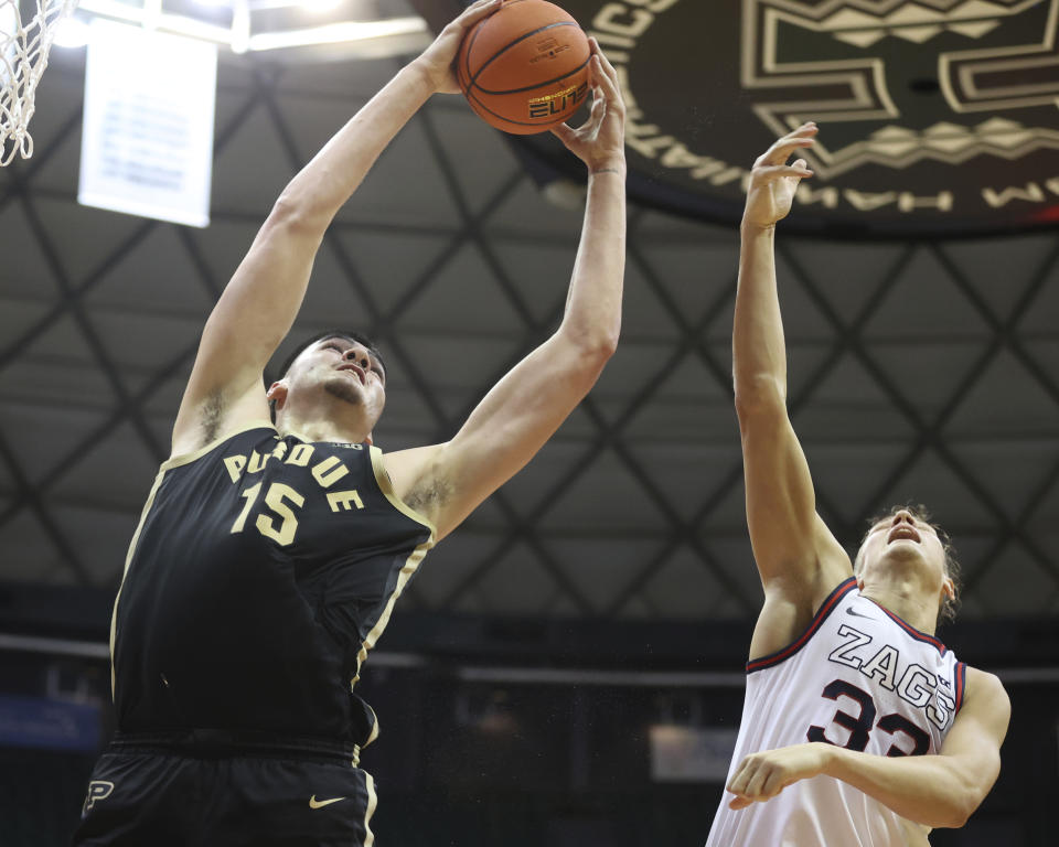 Purdue center Zach Edey (15) grabs a rebound over Gonzaga forward Ben Gregg during the second half of an NCAA college basketball game, Monday, Nov. 20, 2023, in Honolulu. (AP Photo/Marco Garcia)