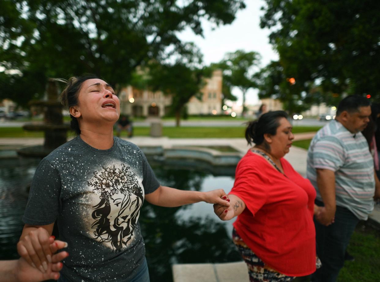 Kladys Castellón prays during a vigil for the victims of a mass shooting at Robb Elementary School in Uvalde, Texas on Tuesday, May 24, 2022.