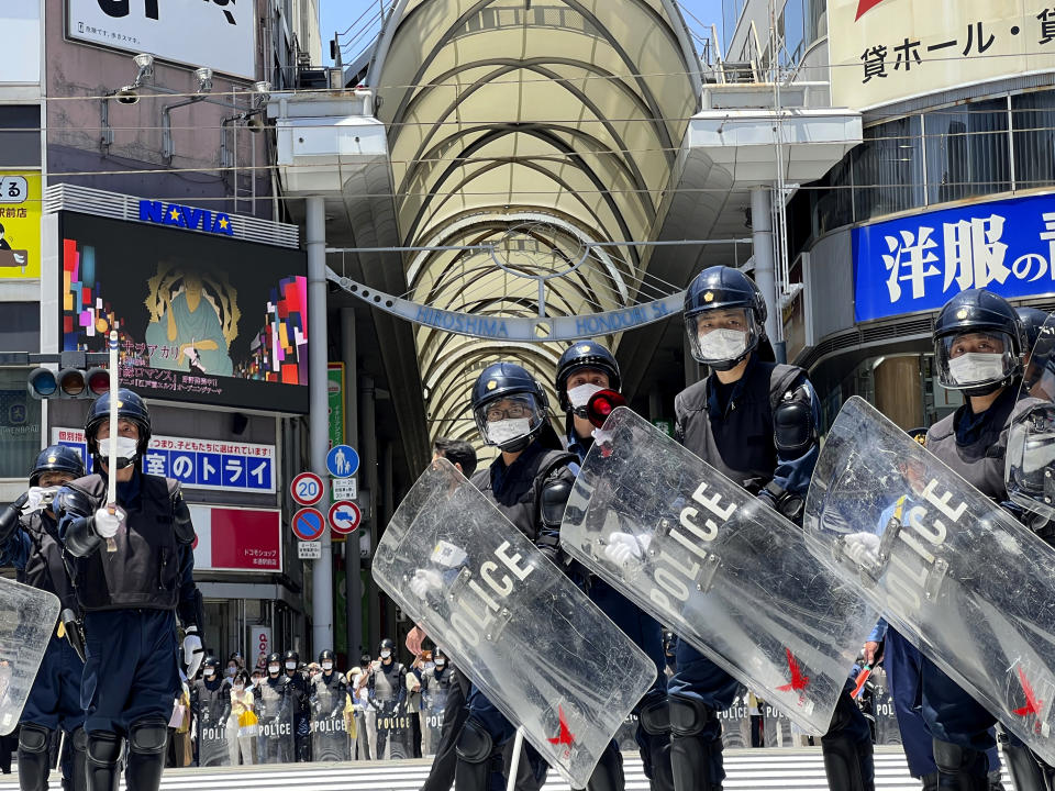 Police prepare to confront protesters marching against the Group of Seven (G7) meeting being held in Hiroshima, western Japan, Sunday, May 21, 2023. (AP Photo/Adam Schreck)