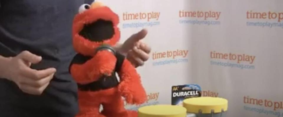 Elmo doll sings into mircophone