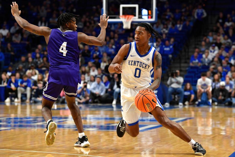 Kentucky guard Rob Dillingham (0) drives around Stonehill guard Se'yphon Triplett (4) during the second half of an NCAA college basketball game in Lexington, Ky., Friday, Nov. 17, 2023. AP Photo/Timothy D. Easley