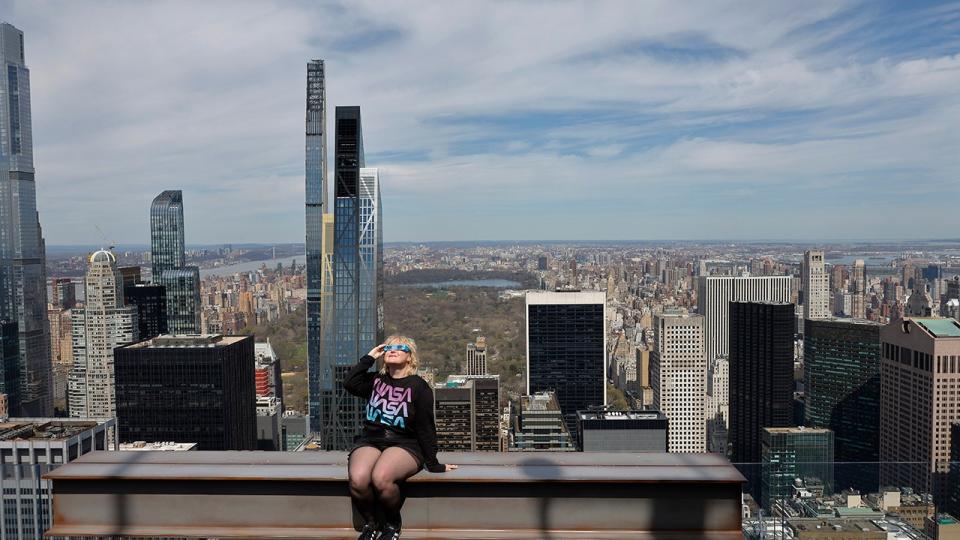 <div>Laura Holden poses for a photo wearing eclipse glasses at the Beam as she prepares to watch a partial solar eclipse from the Top of the Rock at Rockefeller Center on April 08, 2024 in New York City. (Photo by Michael M. Santiago/Getty Images)</div>