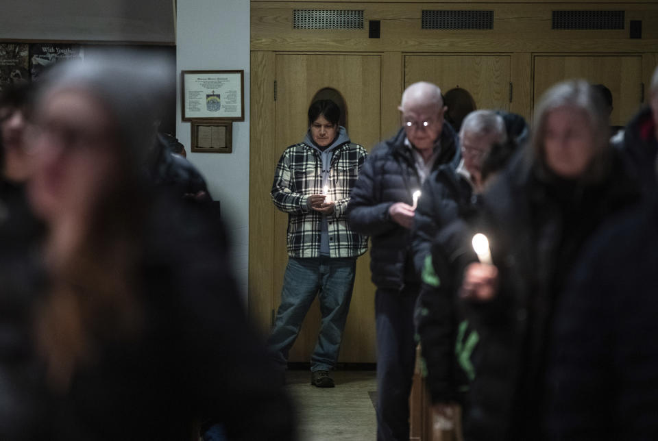 Community members gather and hold a vigil for the six people killed in a plane crash, in Fort Smith, Northwest Territories, on Wednesday, Jan. 24, 2024. (Jason Franson/The Canadian Press via AP)