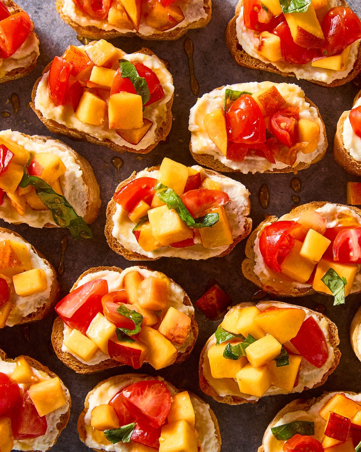 sliced toasts topped peach and tomato slices