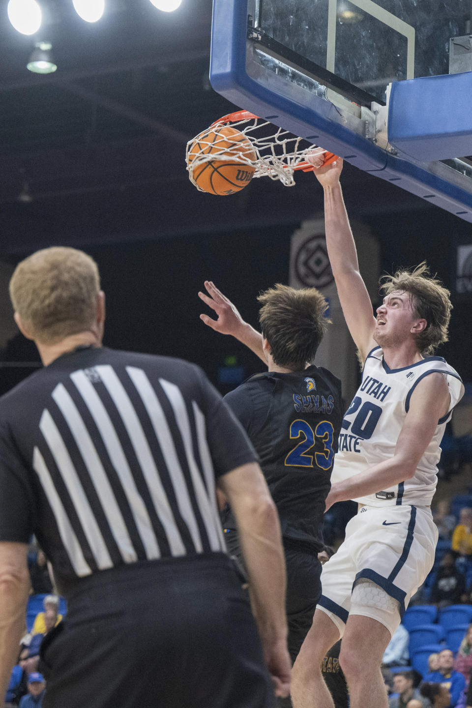 Utah State center Isaac Johnson (20) dunks the ball over San Jose State forward Diogo Seixas (23) during the first half of an NCAA basketball game Wednesday, March 6, 2024, in San Jose, Calif. (AP Photo/Nic Coury)